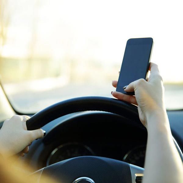 Woman texting behind the wheel