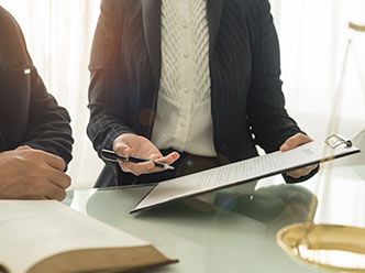 Lawyer presenting clipboard with documentation