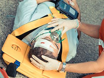 Man in portable stretcher and oxygen mask